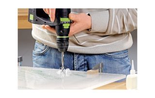 man drilling acrylic sheet