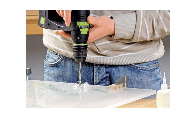 man drilling acrylic sheet